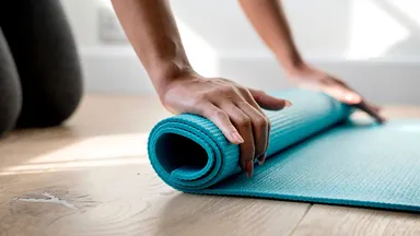 Woman rolling out a yoga mat
